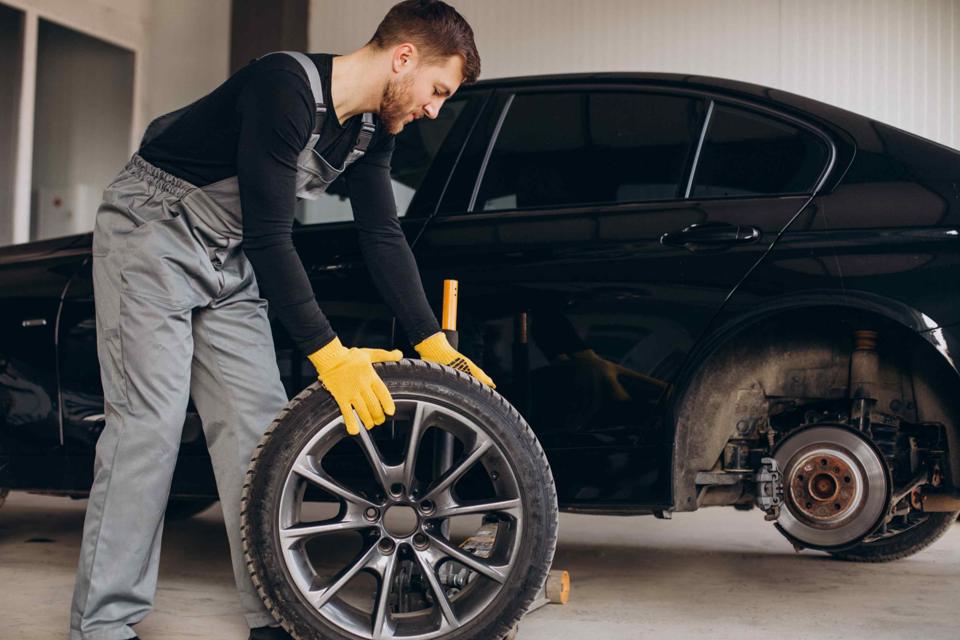car mechanic changing wheels car